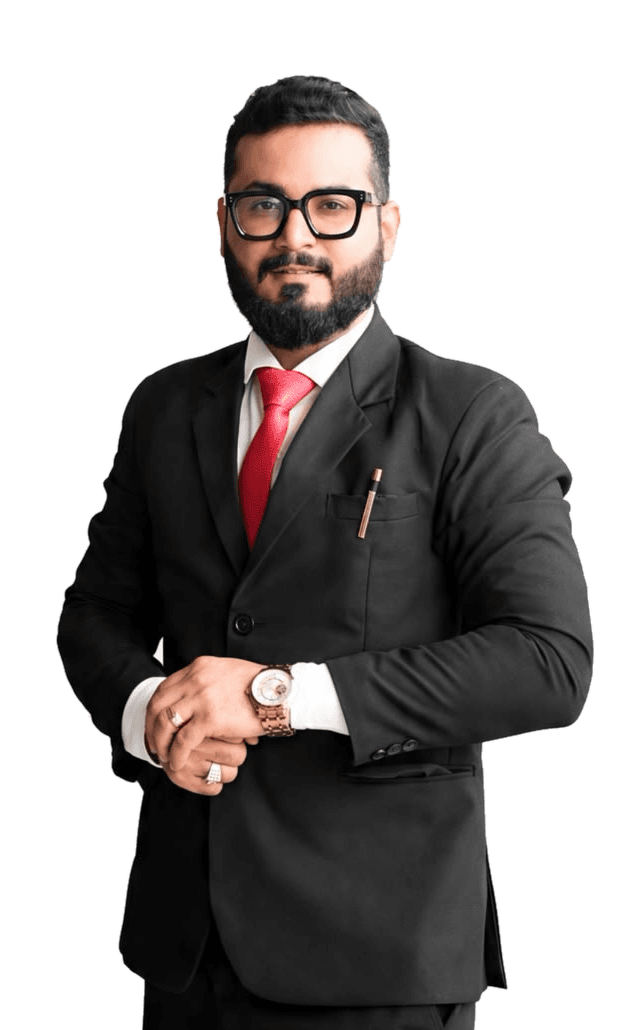 Krishna Rohada in a black suit and red tie, adjusting a wristwatch